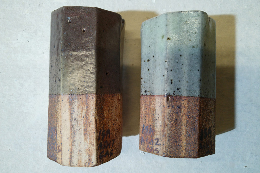 Two ceramic test tiles sit on a table.