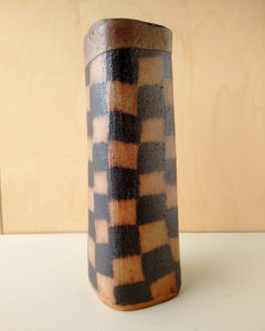 A tall, thin vase with a nerikomi checker pattern.