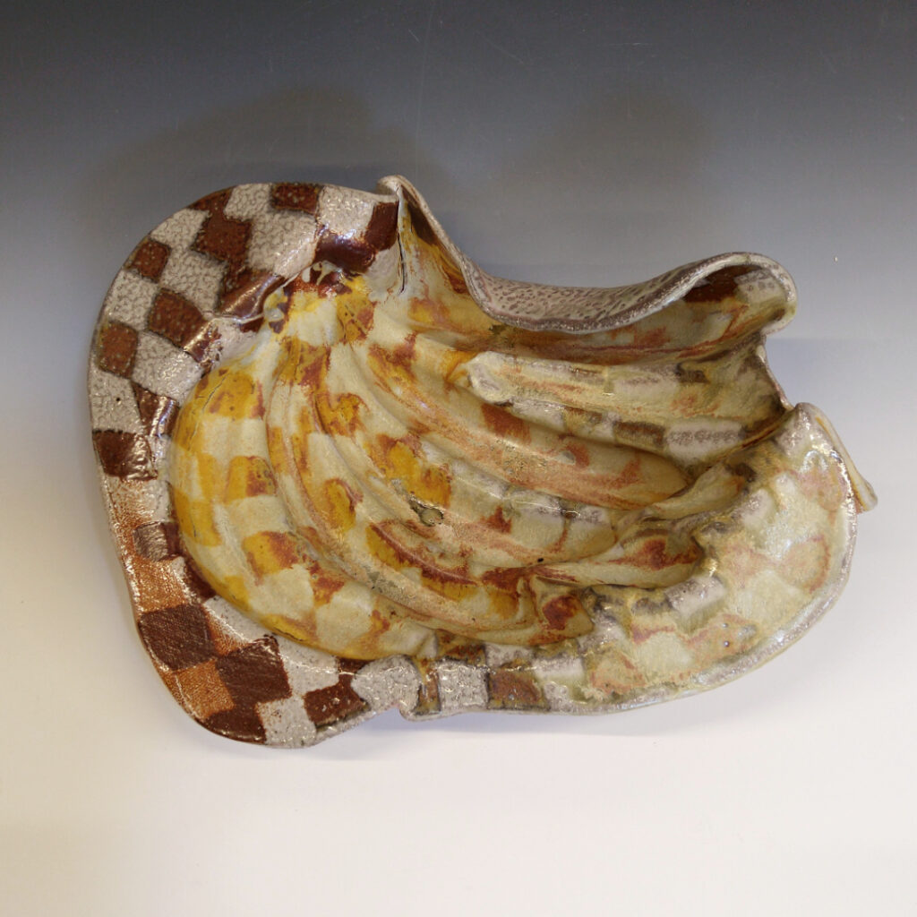 Banana Bowl 01 is a soda-fired ceramic fruit bowl with a sunshine yellow glaze over a warm brown nerikomi checker pattern.