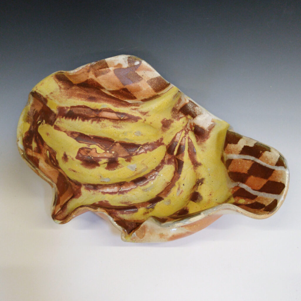Banana Bowl 03 is a soda-fired ceramic fruit bowl with a sunshine yellow glaze over a warm brown nerikomi checker pattern.