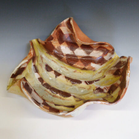 Banana Bowl 04 is a soda-fired ceramic fruit bowl with a sunshine yellow glaze over a warm brown nerikomi checker pattern.