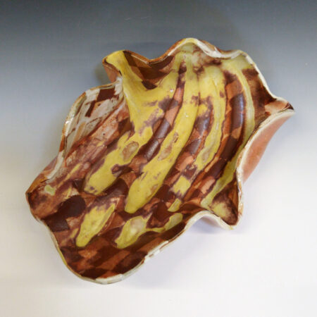 Banana Bowl 05 is a soda-fired ceramic fruit bowl with a sunshine yellow glaze over a warm brown nerikomi checker pattern.