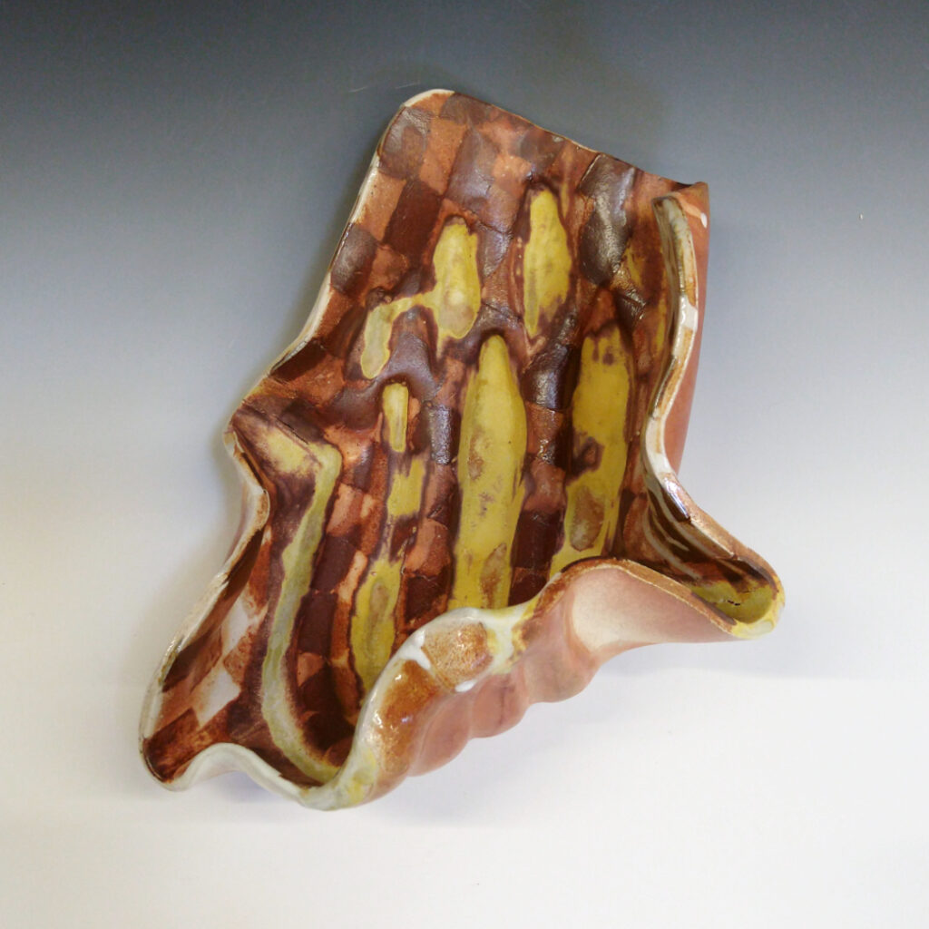 Banana Bowl 05 is a soda-fired ceramic fruit bowl with a sunshine yellow glaze over a warm brown nerikomi checker pattern.