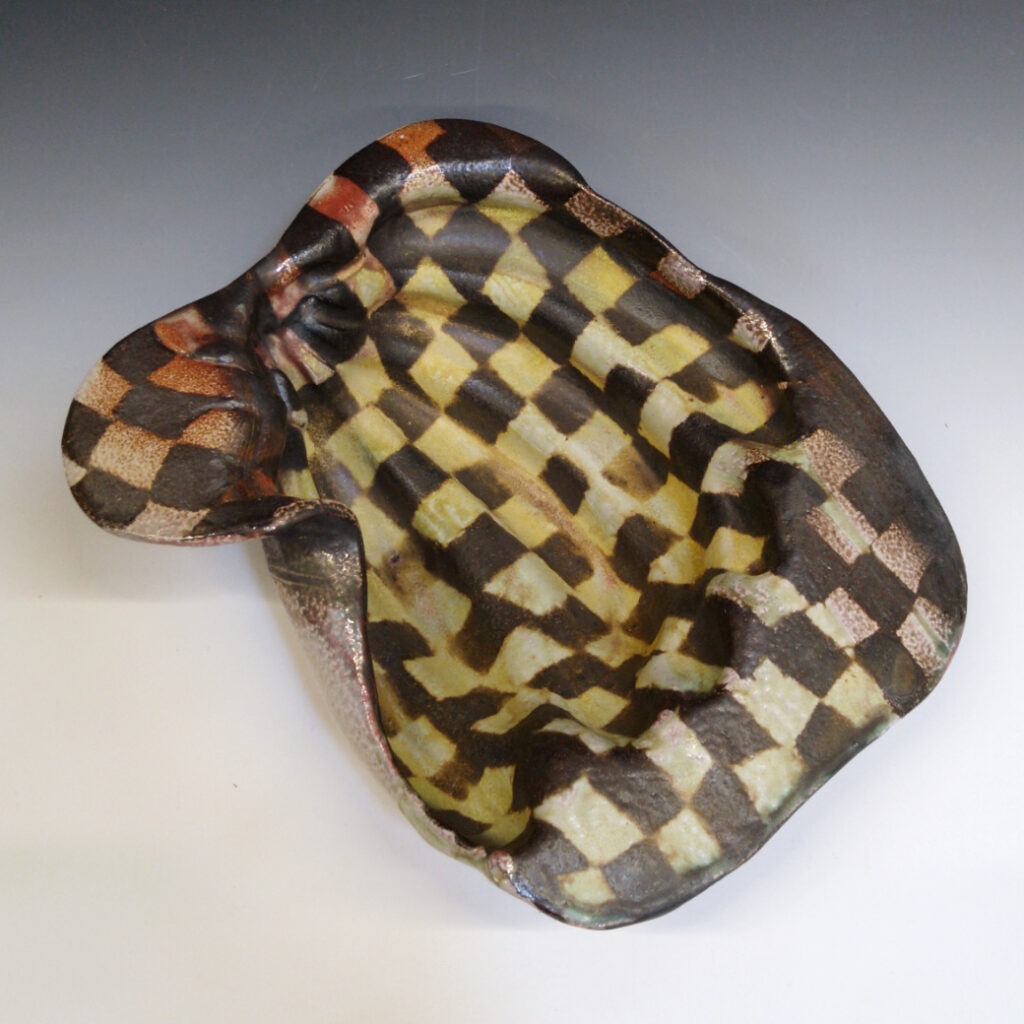 Banana Bowl 07 is a soda-fired ceramic fruit bowl with a sunshine yellow glaze over a warm brown nerikomi checker pattern.