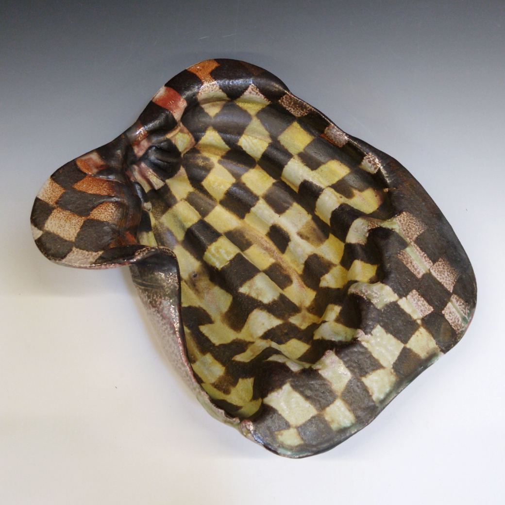 Banana Bowl 07 is a soda-fired ceramic fruit bowl with a sunshine yellow glaze over a warm brown nerikomi checker pattern.