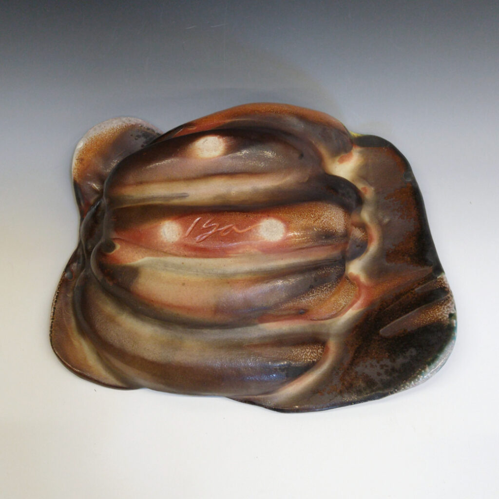 Banana Bowl 07 is a soda-fired ceramic fruit bowl with a sunshine yellow glaze over a warm brown nerikomi checker pattern.