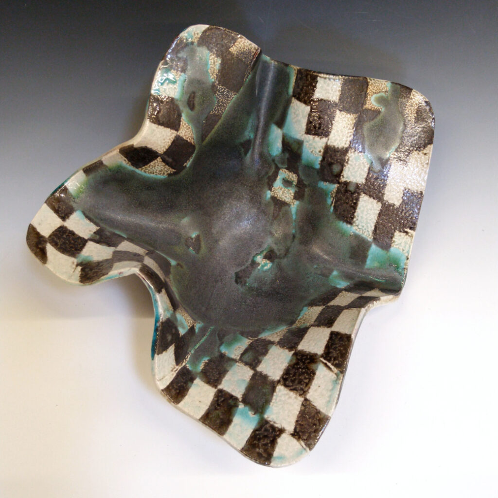 Cantaloupe Bowl 02 is a soda-fired ceramic fruit bowl with a blue-black glaze over a dark brown nerikomi checker pattern.