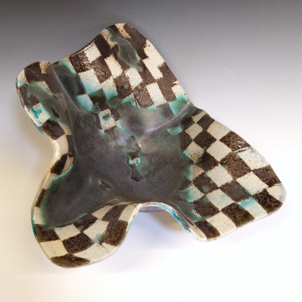 Cantaloupe Bowl 02 is a soda-fired ceramic fruit bowl with a blue-black glaze over a dark brown nerikomi checker pattern.
