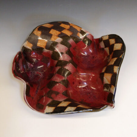 Orange Bowl 01 is a soda-fired ceramic fruit bowl with a blood-red glaze over a dark brown nerikomi checker pattern.